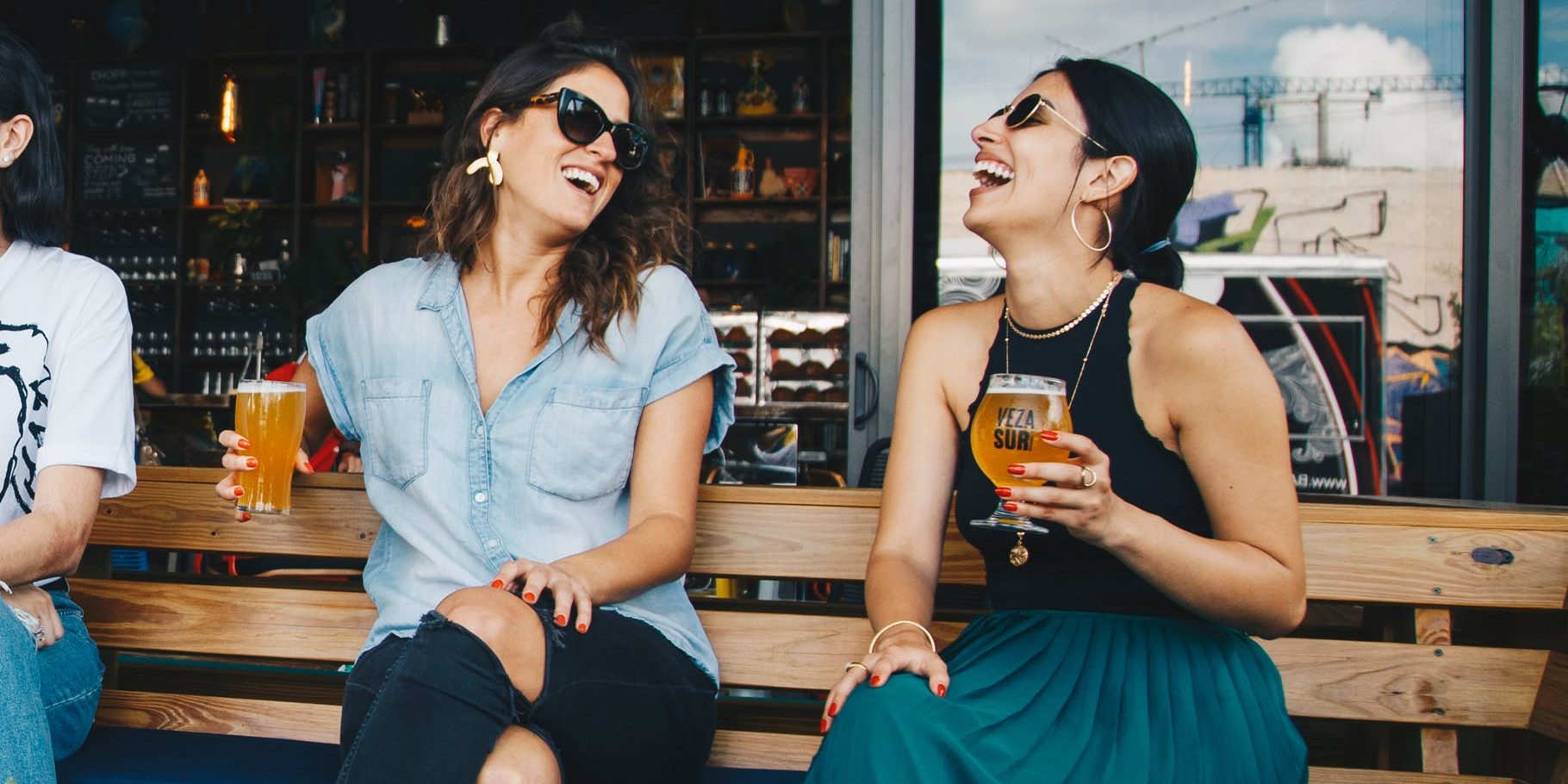 pexels-photo-1267696 two smiling women sitting on wooden bench