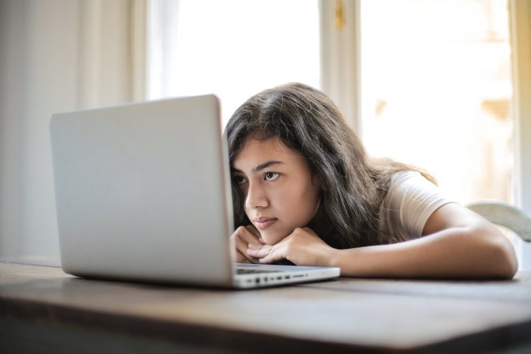 young woman using laptop at home